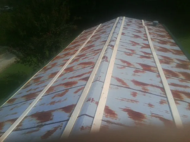 Rusted metal roof panels with new wood purlins before replacement — Storm Damage Roof Repair in Mound City by Roofing Brothers