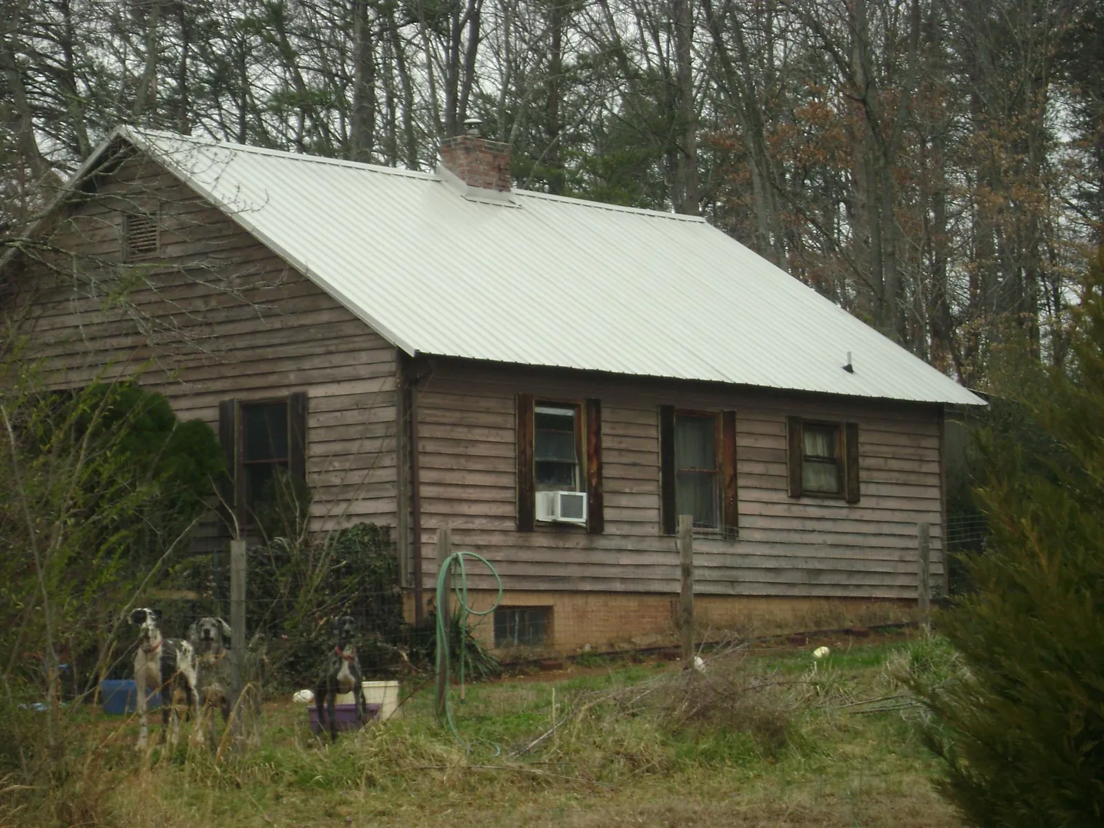 White metal roof on an old wood sided farmhouse, from a Metal Roof Installation job in Mound City